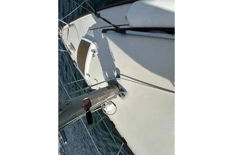 Slide: The Image of 1976 Sabre 28 sailboat deck view, showcasing mast and rigging on open water. - 29
