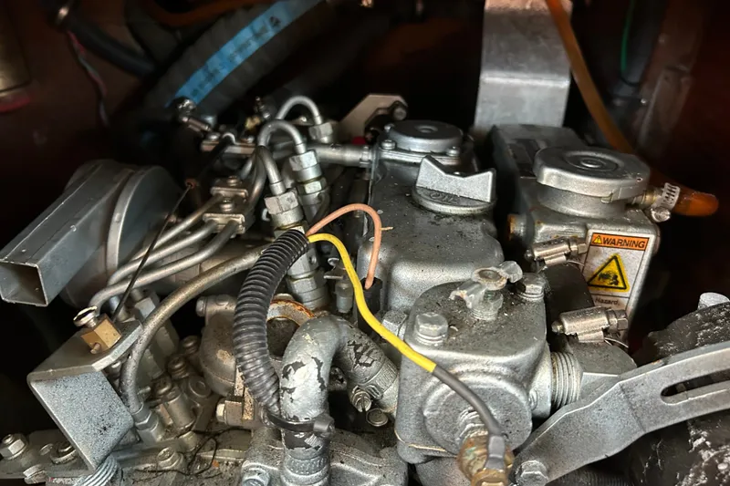 Slide: The Image of Close-up of a 1976 Sabre 28 engine with visible wiring and warning label. - 36