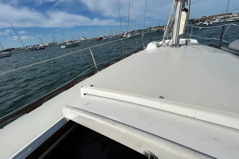 Slide: The Image of 1976 Sabre 28 sailboat deck view with marina background under blue sky. - 25