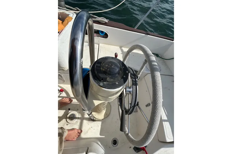 Slide: The Image of Steering wheel of a 1976 Sabre 28 sailboat, with nautical equipment visible. - 31