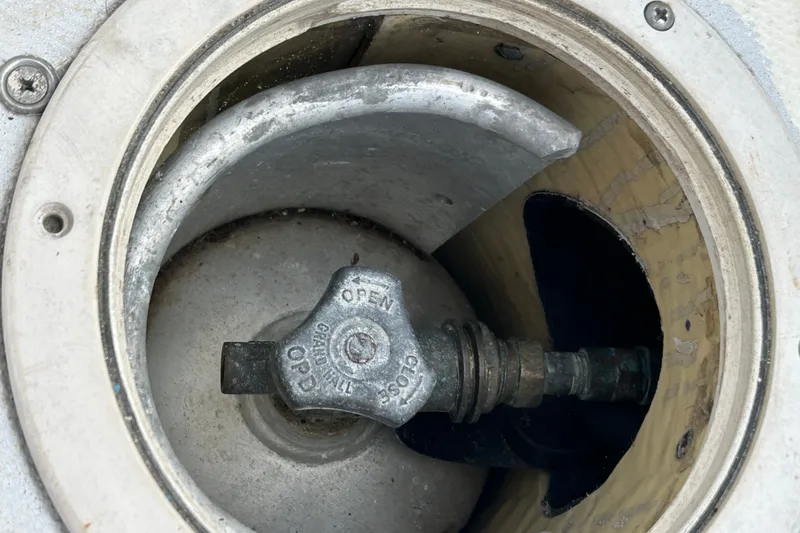 Slide: The Image of Fuel cap of a 1976 Sabre 28 sailboat, showing open valve mechanism. - 44