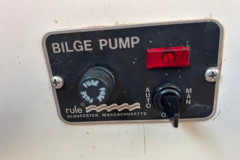 Slide: The Image of Bilge pump control panel on a 1976 Sabre 28 sailboat, featuring auto and manual settings. - 51