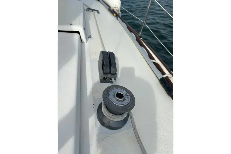 Slide: The Image of Deck of 1976 Sabre 28 sailboat with winch and cleat by the water. - 17