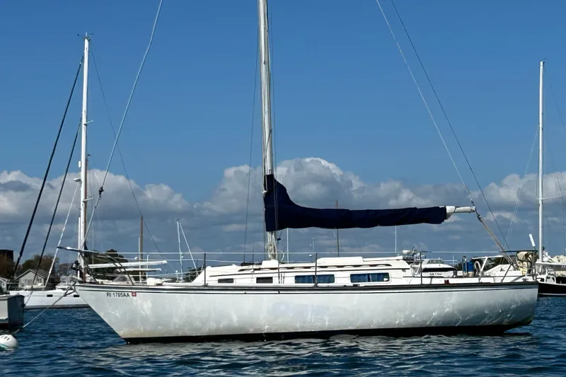 The Image of 1976 Sabre 28 sailboat anchored in a marina under a clear blue sky. - 0