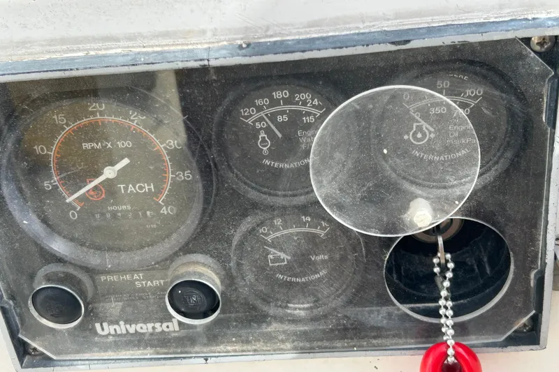 Slide: The Image of Dashboard of a 1976 Sabre 28 sailboat with tachometer and engine gauges. - 32