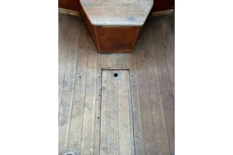 Slide: The Image of Wooden floor of a 1976 Sabre 28 sailboat with a small hatch. - 40