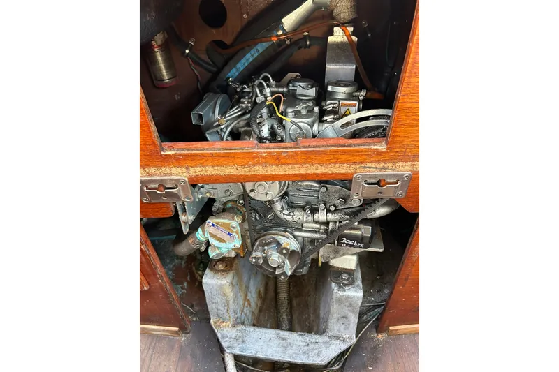 Slide: The Image of 1976 Sabre 28 engine compartment with visible mechanical components and wooden paneling. - 35