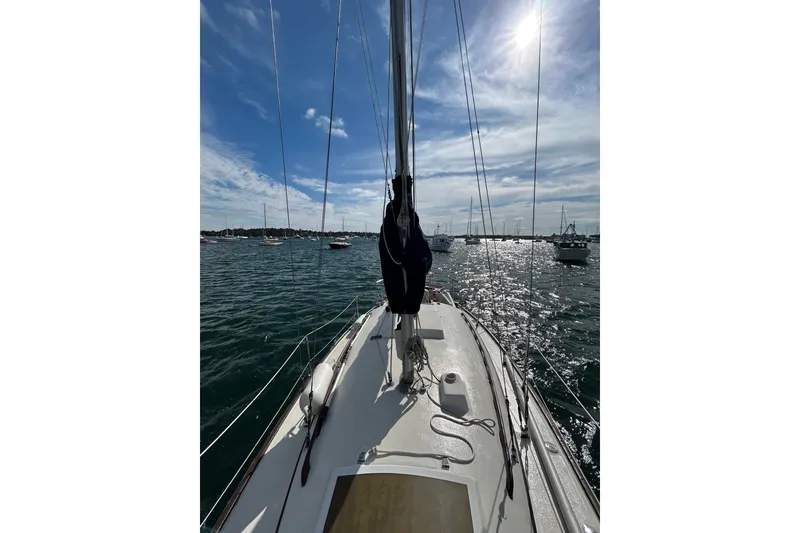 Slide: The Image of Sailing on a 1976 Sabre 28 yacht under a sunny sky with calm waters. - 30