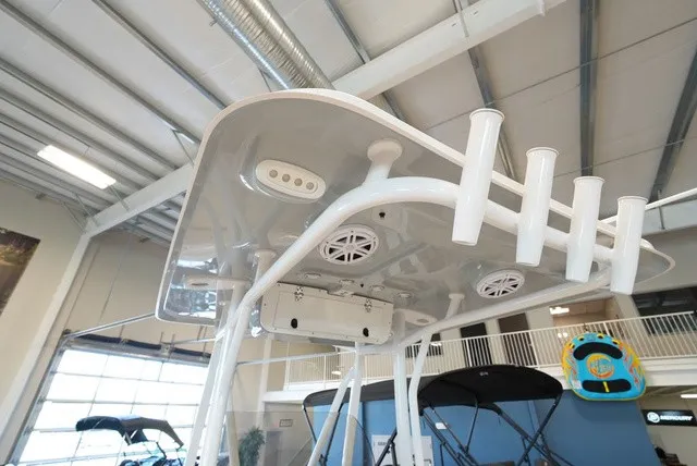Slide: The Image of The image shows the T-top of a Sea Hunt Ultra 229 with speakers and rod holders. - 14