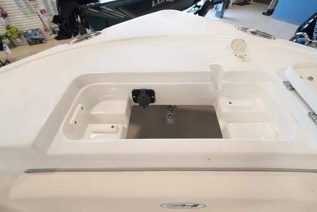 Slide: The Image of The image shows the bow area of a Sea Hunt Ultra 229 boat with storage space. - 32