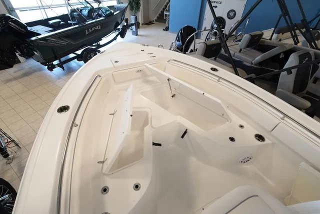 Slide: The Image of The image shows the deck of a Sea Hunt Ultra 229 boat with storage and seating areas. - 30