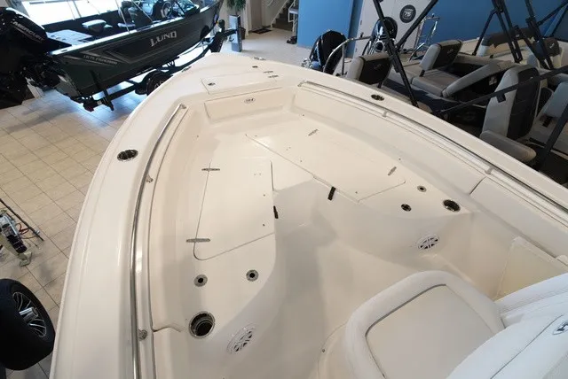 Slide: The Image of The image shows the deck of a Sea Hunt Ultra 229 boat with seating and storage areas. - 29