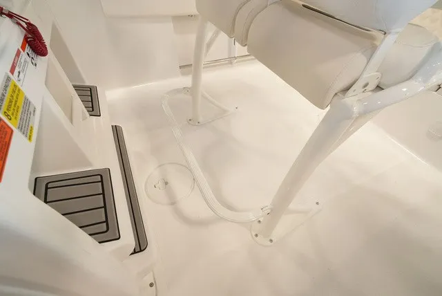 Slide: The Image of Close-up of a Sea Hunt Ultra 229 cockpit floor with white seating and non-slip footrests. - 17