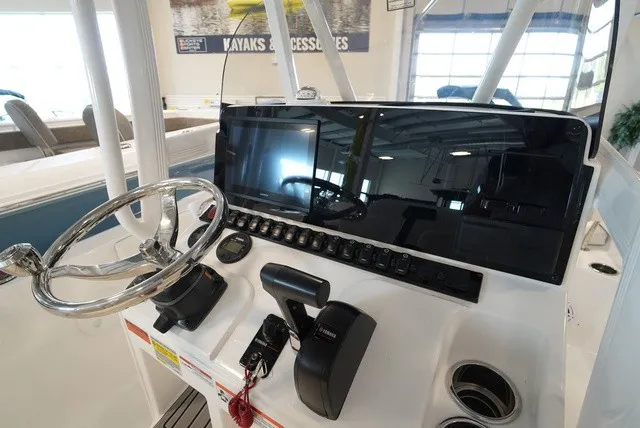 Slide: The Image of The image shows the helm of a Sea Hunt Ultra 229 boat with a modern display and controls. - 22