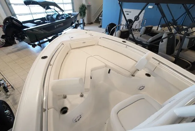 Slide: The Image of The image shows the deck of a 2027 Sea Hunt Ultra 229 boat in a showroom. - 28