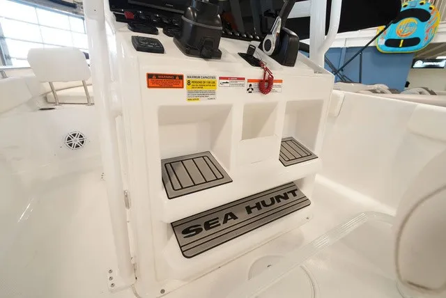 Slide: The Image of Interior view of a Sea Hunt Ultra 229 boat with a helm console and steps. - 18