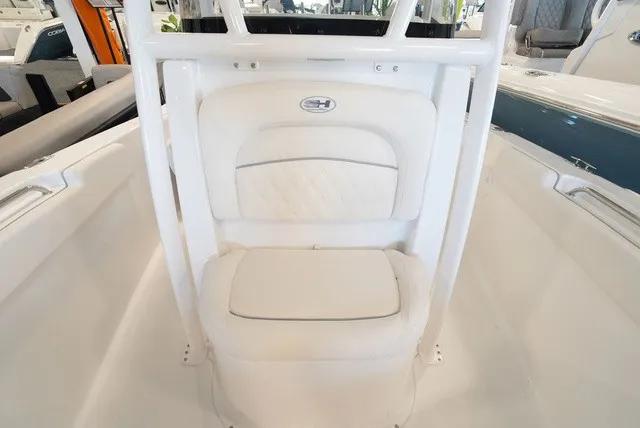 Slide: The Image of The image shows the seating area of a 2027 Sea Hunt Ultra 229 boat with white upholstery. - 33