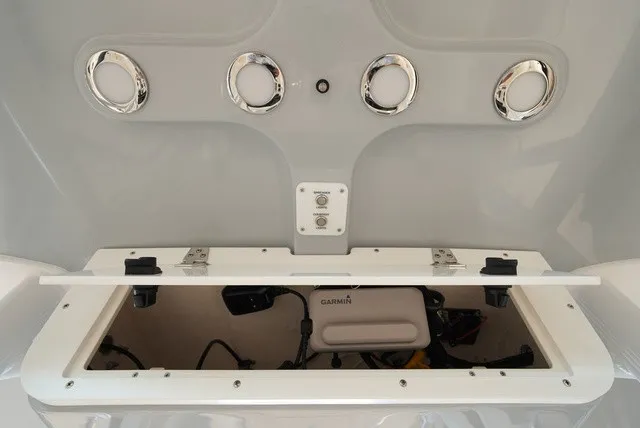 Slide: The Image of The image shows the storage compartment of a Sea Hunt Ultra 229 boat with electronic equipment. - 21