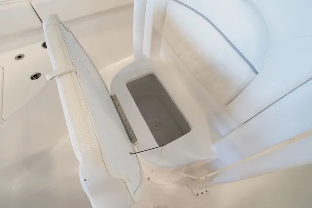 Slide: The Image of A white seat with an open storage compartment underneath on a boat. - 34