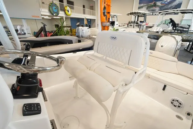 Slide: The Image of Interior view of a Sea Hunt Ultra 229 with white seating and helm station. - 16