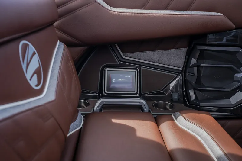 Slide: The Image of Interior of 2026 Tigé Ultré 25ZX boat with brown leather seating and control panel. - 28