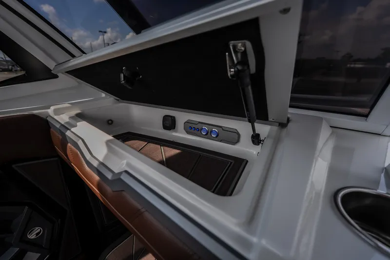 Slide: The Image of 2026 Tigé Ultré 25ZX boat interior storage compartment with control buttons. - 54