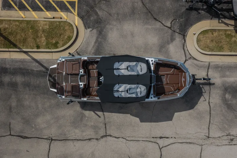 Slide: The Image of Aerial view of 2026 Tigé Ultré 25ZX boat with brown seating and black covers. - 63