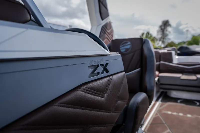 Slide: The Image of 2026 Tigé Ultré 25ZX boat interior with luxurious brown leather seating. - 52