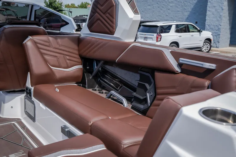 Slide: The Image of Luxurious interior of 2026 Tigé Ultré 25ZX boat with brown leather seating. - 24
