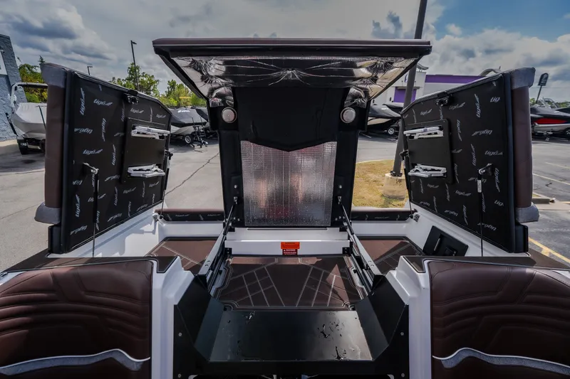 Slide: The Image of 2026 Tigé Ultré 25ZX boat interior with open storage compartments and sleek design. - 36