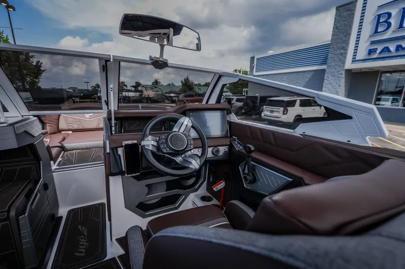 Slide: The Image of Interior view of 2026 Tigé Ultré 25ZX boat, featuring modern dashboard and steering wheel. - 40