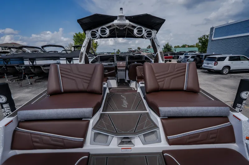 Slide: The Image of 2026 Tigé Ultré 25ZX boat with luxurious brown seating and modern design. - 25