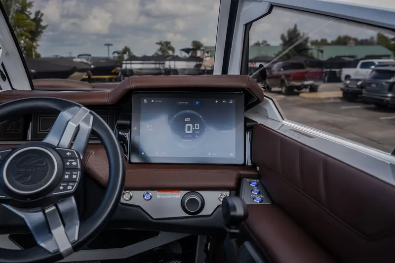 Slide: The Image of 2026 Tigé Ultré 25ZX boat dashboard with touchscreen and steering wheel. - 43