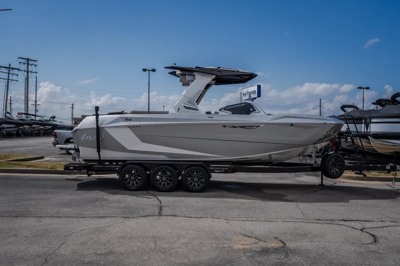 Slide: The Image of 2026 Tigé Ultré 25ZX boat on trailer, parked outdoors under blue sky. - 3