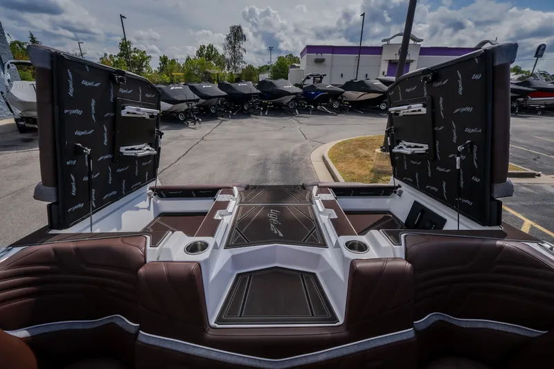 Slide: The Image of 2026 Tigé Ultré 25ZX boat interior with open storage compartments, showcasing luxury seating and design. - 34