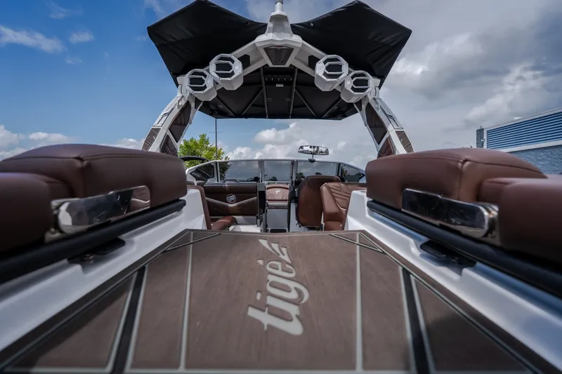 Slide: The Image of 2026 Tigé Ultré 25ZX boat interior with brown seating and sleek design. - 23
