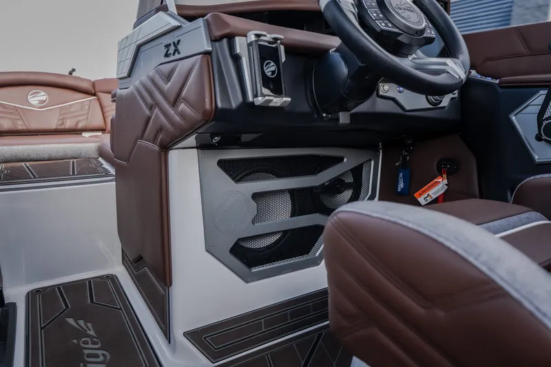 Slide: The Image of 2026 Tigé Ultré 25ZX boat interior with brown leather seats and modern dashboard design. - 38