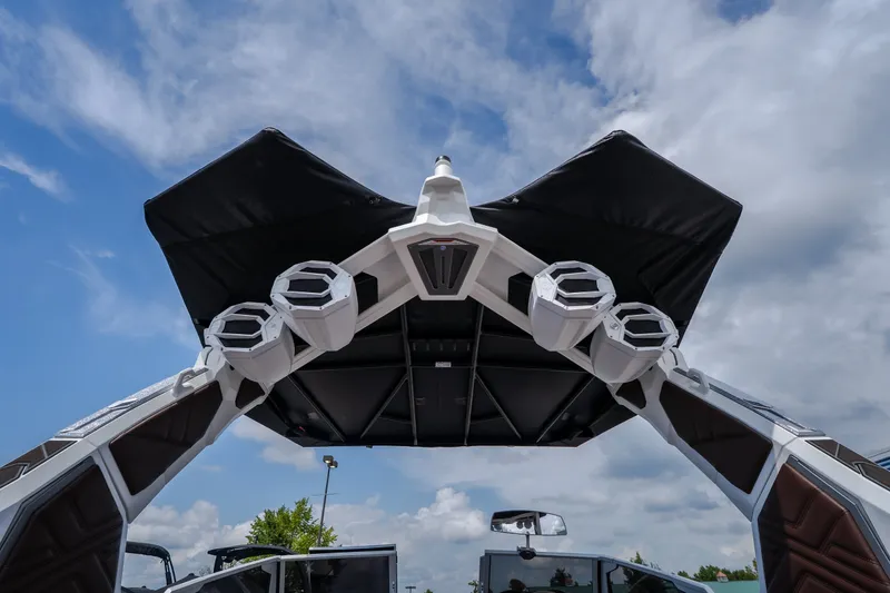 Slide: The Image of 2026 Tigé Ultré 25ZX boat tower with speakers against a cloudy sky. - 32