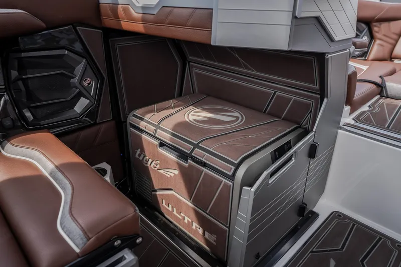 Slide: The Image of Interior of 2026 Tigé Ultré 25ZX boat featuring stylish seating and integrated cooler. - 27