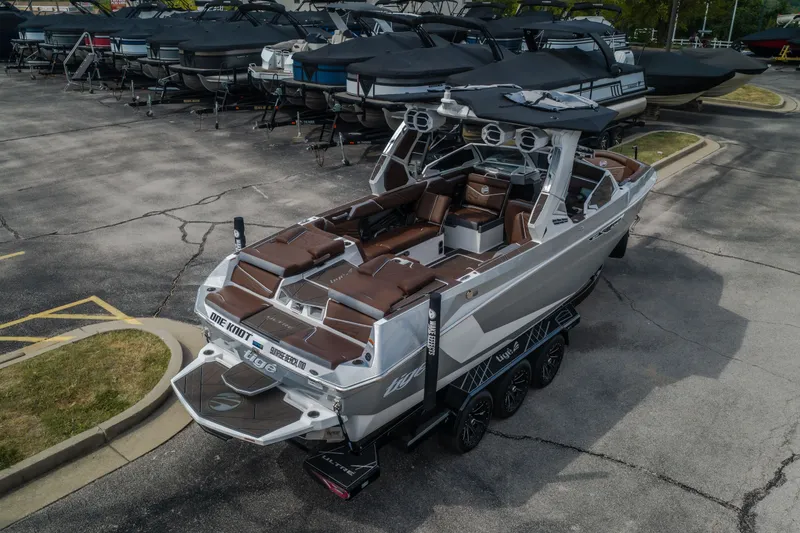 Slide: The Image of 2026 Tigé Ultré 25ZX boat on trailer, parked in a marina lot. - 61