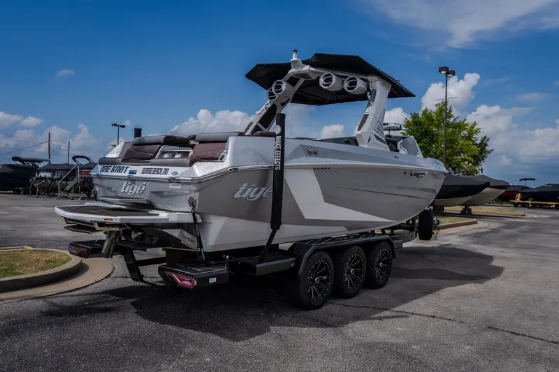 Slide: The Image of 2026 Tigé Ultré 25ZX boat on trailer in parking lot, under blue sky. - 4