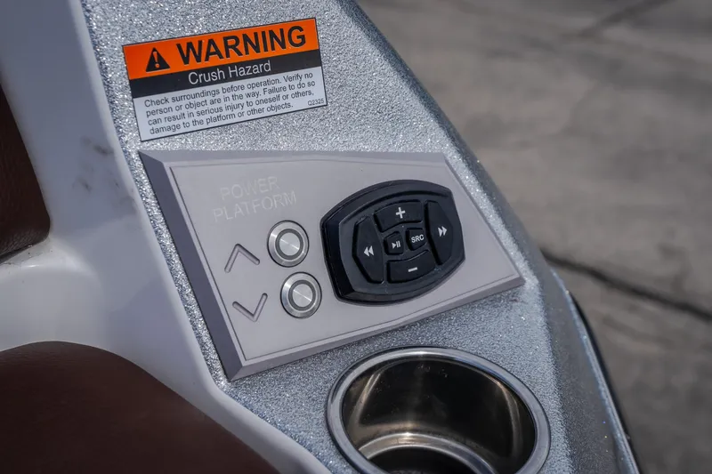 Slide: The Image of Control panel of 2026 Tigé Ultré 25ZX boat with warning label and cup holder. - 20