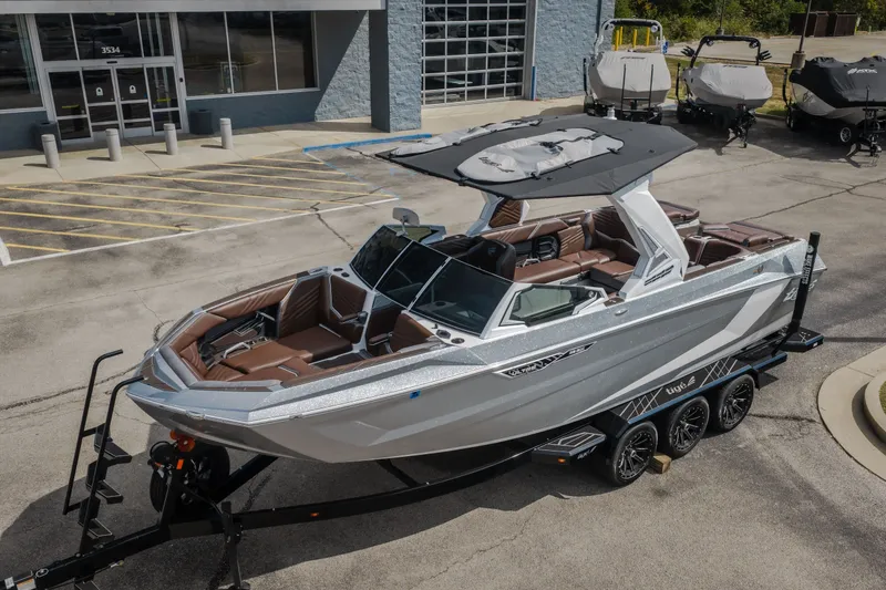 Slide: The Image of 2026 Tigé Ultré 25ZX boat on trailer, parked outside dealership. - 64