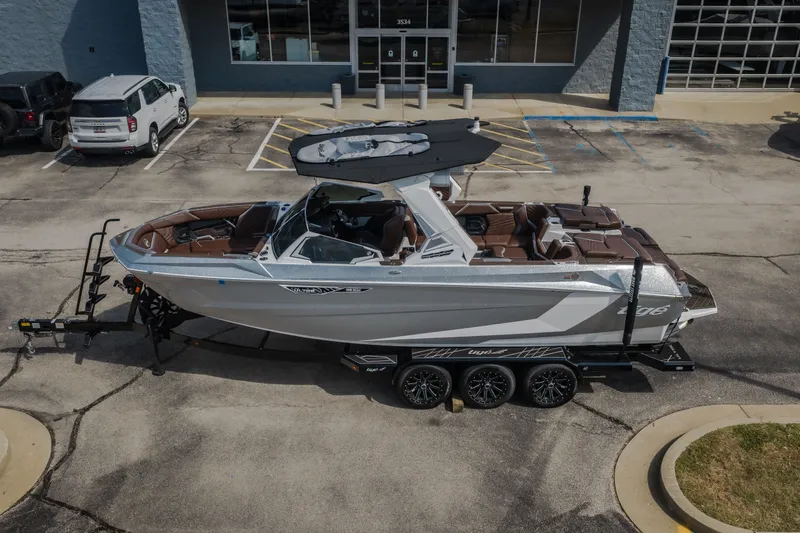 Slide: The Image of 2026 Tigé Ultré 25ZX boat on trailer in parking lot. - 60