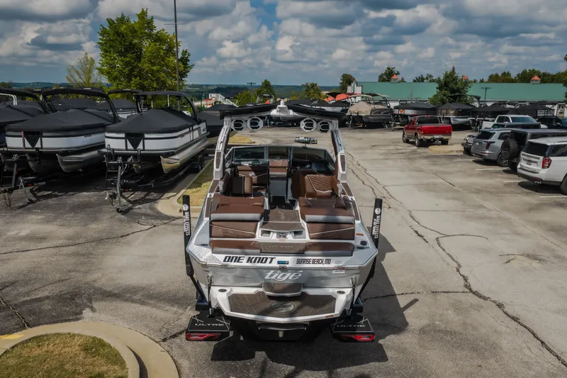 Slide: The Image of 2026 Tigé Ultré 25ZX boat in a marina parking lot, surrounded by other boats and vehicles. - 62