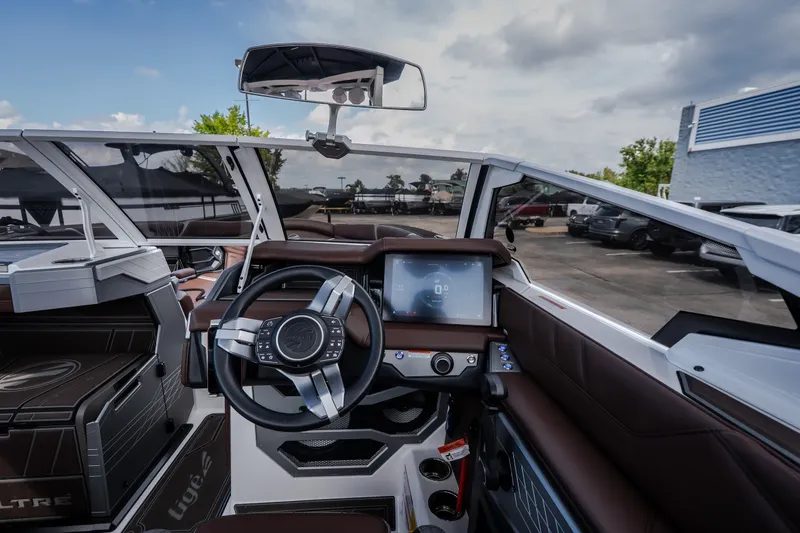 Slide: The Image of 2026 Tigé Ultré 25ZX boat interior with modern dashboard and steering wheel. - 42
