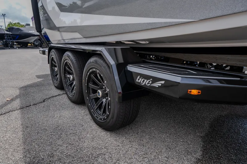 Slide: The Image of 2026 Tigé Ultré 25ZX boat trailer with sleek black wheels and branding. - 9