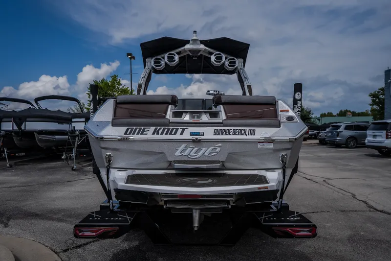 Slide: The Image of 2026 Tigé Ultré 25ZX boat at a marina, showcasing sleek design and modern features. - 11