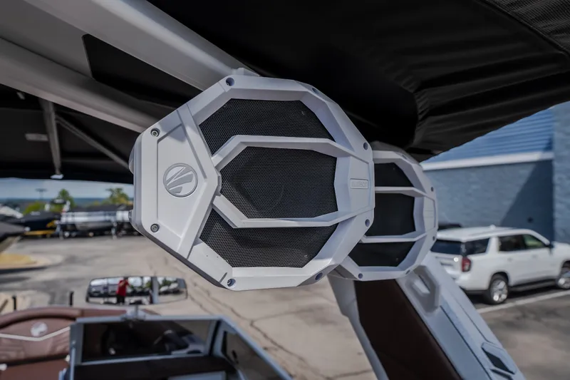 Slide: The Image of 2026 Tigé Ultré 25ZX boat with premium audio speakers, parked outdoors. - 56