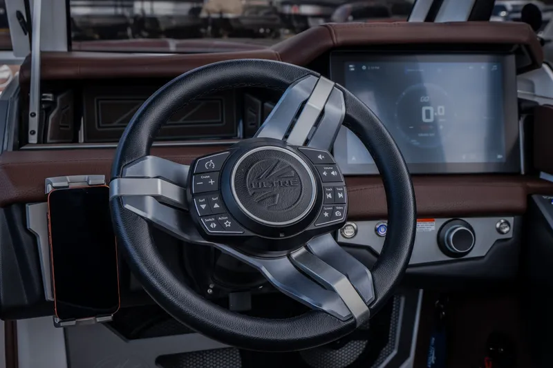 Slide: The Image of Steering wheel and dashboard of 2026 Tigé Ultré 25ZX boat with touchscreen display. - 41